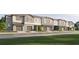 Charming townhome exterior featuring a row of attached homes and individual garages at 9317 Bonita Mar Dr, Parrish, FL 34219