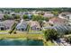 Aerial view of a neighborhood showcasing homes, green spaces, and a scenic pond at 10108 36Th E Ct, Parrish, FL 34219