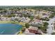Scenic aerial view showcasing a neighborhood by the lake with lush greenery and well-kept lawns at 10108 36Th E Ct, Parrish, FL 34219
