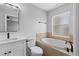 Relaxing bathroom featuring a soaking tub, large vanity and frosted window at 10108 36Th E Ct, Parrish, FL 34219