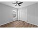 Cozy bedroom with wood-look floors, a ceiling fan and bright natural light at 10108 36Th E Ct, Parrish, FL 34219