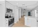 Modern kitchen with stainless steel appliances and white cabinets at 10108 36Th E Ct, Parrish, FL 34219