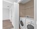 Convenient laundry area with side by side appliances and wire shelving for storage at 10108 36Th E Ct, Parrish, FL 34219