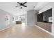 Bright living room featuring tile floors, modern ceiling fan and a decorative wall panel at 10108 36Th E Ct, Parrish, FL 34219