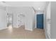 Bright, open living area with neutral paint, a tile floor, and a blue front door at 10108 36Th E Ct, Parrish, FL 34219