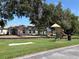 A community playground with swings and slides, surrounded by lush greenery and landscaping at 10108 36Th E Ct, Parrish, FL 34219