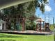 A community playground with swings, slides, and a play structure in a grassy area at 10108 36Th E Ct, Parrish, FL 34219