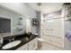 Bathroom featuring granite vanity, walk-in shower, and ample lighting at 1110 Rose Blossom Ct, Tampa, FL 33613