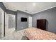 Bedroom featuring tile floors, gray walls, and closet space at 1110 Rose Blossom Ct, Tampa, FL 33613