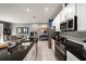 Modern kitchen featuring granite countertops, white cabinets, and stainless steel appliances, adjacent to dining at 1110 Rose Blossom Ct, Tampa, FL 33613