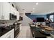 Modern kitchen featuring granite countertops, white cabinets, and stainless steel appliances, adjacent to dining at 1110 Rose Blossom Ct, Tampa, FL 33613