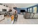 Bright open-concept living space featuring tile floors, an island bar and contemporary furnishings at 1110 Rose Blossom Ct, Tampa, FL 33613