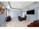 Spacious living room features tile floors, blue accent walls, recessed lighting, and modern furniture at 1110 Rose Blossom Ct, Tampa, FL 33613
