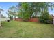 Spacious backyard featuring lush lawn, mature trees, and privacy fencing at 12280 Waco St, Spring Hill, FL 34609