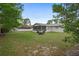 Large backyard with green grass, fenced perimeter, and screened porch, great for outdoor enjoyment at 12280 Waco St, Spring Hill, FL 34609