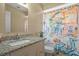Bathroom featuring granite countertop vanity and a vibrant scooter-themed shower curtain at 12280 Waco St, Spring Hill, FL 34609