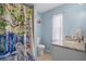 Stylish bathroom with a modern shower curtain, blue walls, and granite vanity at 12280 Waco St, Spring Hill, FL 34609