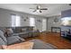 Comfortable living room with hardwood floors, sectional sofa, and views of the front yard at 12280 Waco St, Spring Hill, FL 34609