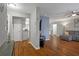 Open-concept living room with hardwood floors, gray walls, and an adjacent kitchen and hallway at 12280 Waco St, Spring Hill, FL 34609