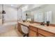 Well-lit bathroom featuring double vanity, a soaking tub, and a separate glass enclosed shower at 12519 Safari Ln, Riverview, FL 33579