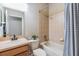 Cozy bathroom with shower-tub combo, tiled walls, and functional vanity for convenience at 12519 Safari Ln, Riverview, FL 33579