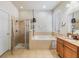 Bright bathroom with a separate shower and tub setup, with tile flooring and neutral color palette at 12519 Safari Ln, Riverview, FL 33579