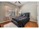 Cozy bedroom with hardwood floors, neutral walls, and a ceiling fan for added comfort at 12519 Safari Ln, Riverview, FL 33579