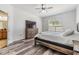 Comfortable bedroom with wood floors, large window, ceiling fan and warm, neutral color scheme at 12519 Safari Ln, Riverview, FL 33579