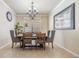 Inviting dining room features tile flooring, modern lighting fixture, and a large window at 12519 Safari Ln, Riverview, FL 33579