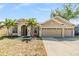 Attractive single-Gathering home with a three-car garage, manicured lawn, and palm trees at 12519 Safari Ln, Riverview, FL 33579