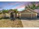 Charming single-story home with a well-manicured lawn, palm trees, and a three-car garage at 12519 Safari Ln, Riverview, FL 33579