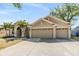 Spacious home featuring a three car garage with an extra long driveway and manicured landscaping at 12519 Safari Ln, Riverview, FL 33579