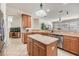 Kitchen with granite counters, wood cabinets, tile floors, stainless appliances and bar seating at 12519 Safari Ln, Riverview, FL 33579