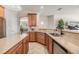 Spacious kitchen showcasing granite counters, wood cabinets, tile floors and stainless steel appliances at 12519 Safari Ln, Riverview, FL 33579