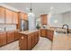 Bright kitchen featuring wood cabinets, stainless steel appliances, granite counters and tile floors at 12519 Safari Ln, Riverview, FL 33579