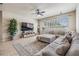 Comfortable living room features a large sectional sofa, stylish rug, and plenty of natural light at 12519 Safari Ln, Riverview, FL 33579