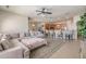 Spacious living room open to kitchen with an oversized couch, kitchen bar and natural light at 12519 Safari Ln, Riverview, FL 33579