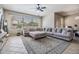 Bright and airy living room with neutral tones, a large sectional sofa, and tile flooring at 12519 Safari Ln, Riverview, FL 33579