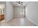 Bright living area with a ceiling fan and open view into the bathroom, and tile flooring at 12519 Safari Ln, Riverview, FL 33579