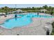 Large community pool with cabanas, lounge chairs, and a splash pad for children at 12519 Safari Ln, Riverview, FL 33579