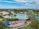 Aerial view of the community pool, playground and lake shows a relaxing and fun space for residents to enjoy the outdoors at 12519 Safari Ln, Riverview, FL 33579