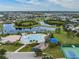 Aerial view of a community pool near the lake with playground, tennis courts and parking offer many activities for homeowners at 12519 Safari Ln, Riverview, FL 33579