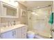 Bathroom featuring a glass enclosed shower, modern vanity, and ample lighting at 1309 Pine Ridge E Cir # H3, Tarpon Springs, FL 34688