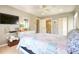 Spacious bedroom with closet, ceiling fan, TV, and a view of the en suite bathroom at 1309 Pine Ridge E Cir # H3, Tarpon Springs, FL 34688