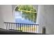 Scenic view of a fountain on a lake through an arched opening with a black metal safety railing at 1309 Pine Ridge E Cir # H3, Tarpon Springs, FL 34688