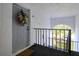 Gray front door with floral wreath, welcome mat, and unit number H3 located in a white hallway at 1309 Pine Ridge E Cir # H3, Tarpon Springs, FL 34688