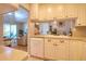 Kitchen view showcasing white cabinets, countertops, and seamless transition to living area at 1309 Pine Ridge E Cir # H3, Tarpon Springs, FL 34688