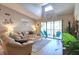 Bright and open living room with a sliding glass door that leads to a balcony with blue Adirondack chairs at 1309 Pine Ridge E Cir # H3, Tarpon Springs, FL 34688