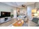 Inviting living room with a ceiling fan and an open layout connecting to the kitchen and dining area at 1309 Pine Ridge E Cir # H3, Tarpon Springs, FL 34688
