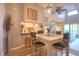 View of the dining table, kitchen and living room in an open-concept living space with light-colored walls at 1309 Pine Ridge E Cir # H3, Tarpon Springs, FL 34688